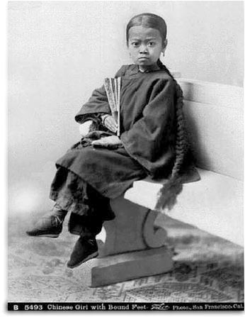 19th century photograph of young girl with bound feet and lotus shoes. Photo by I. W. Taber