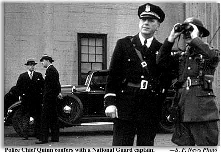Police Chief Quinn confers with National Guard captain